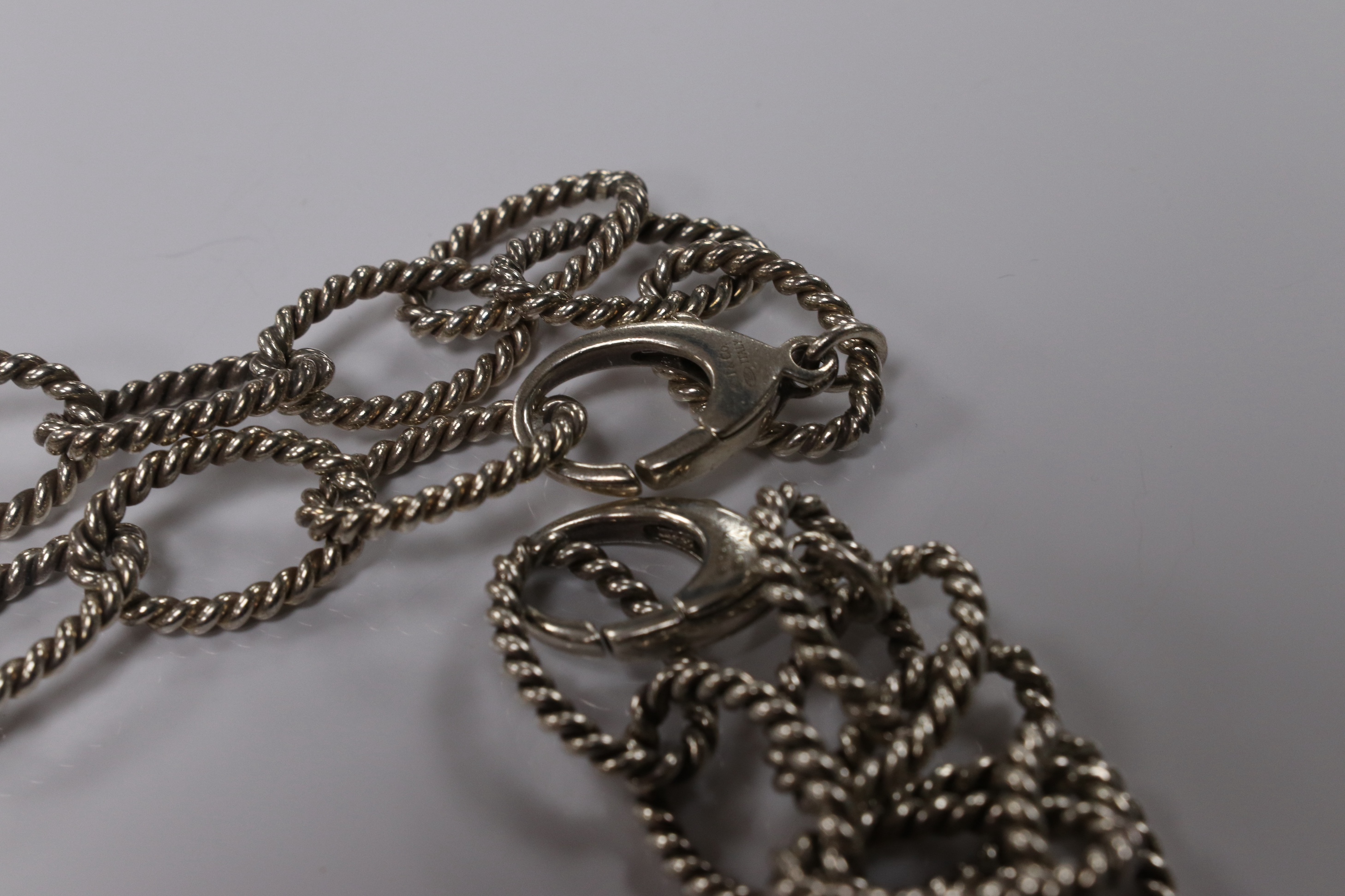 A modern Italian Tiffany & Co 925 suite of jewellery, of rope twist design, comprising a necklace, 42cm, bracelet, 18cm and two rings, size O/P and O. Condition - fair to good